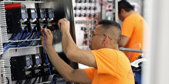 The wiring team gets creative with cable management.